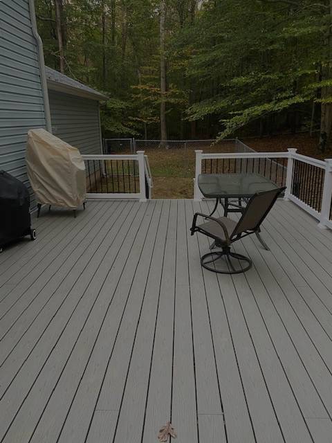 view of the chair and white color fencing at the deck